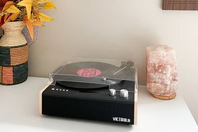 Vivtrola record player on table with decorative vase